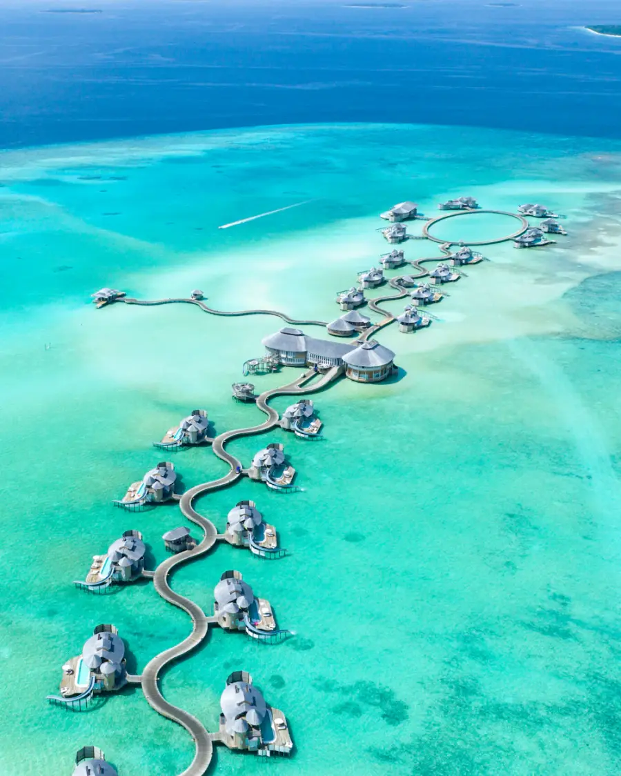 Overwater villas stretching across a turquoise Maldivian lagoon
