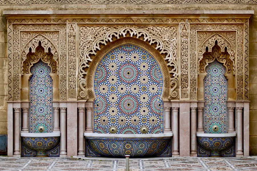 Intricate Moroccan mosaic fountains and carved stone architecture